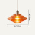 Orange glass tiered pendant light with brushed nickel fixture hanging against white background.