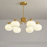 "A 6-light round chandelier with opal glass globes and a gold metal frame, hanging from a ceiling in a room."
