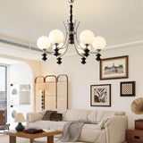 "Modern chandelier with curved arms and frosted glass globes illuminating a contemporary living room."