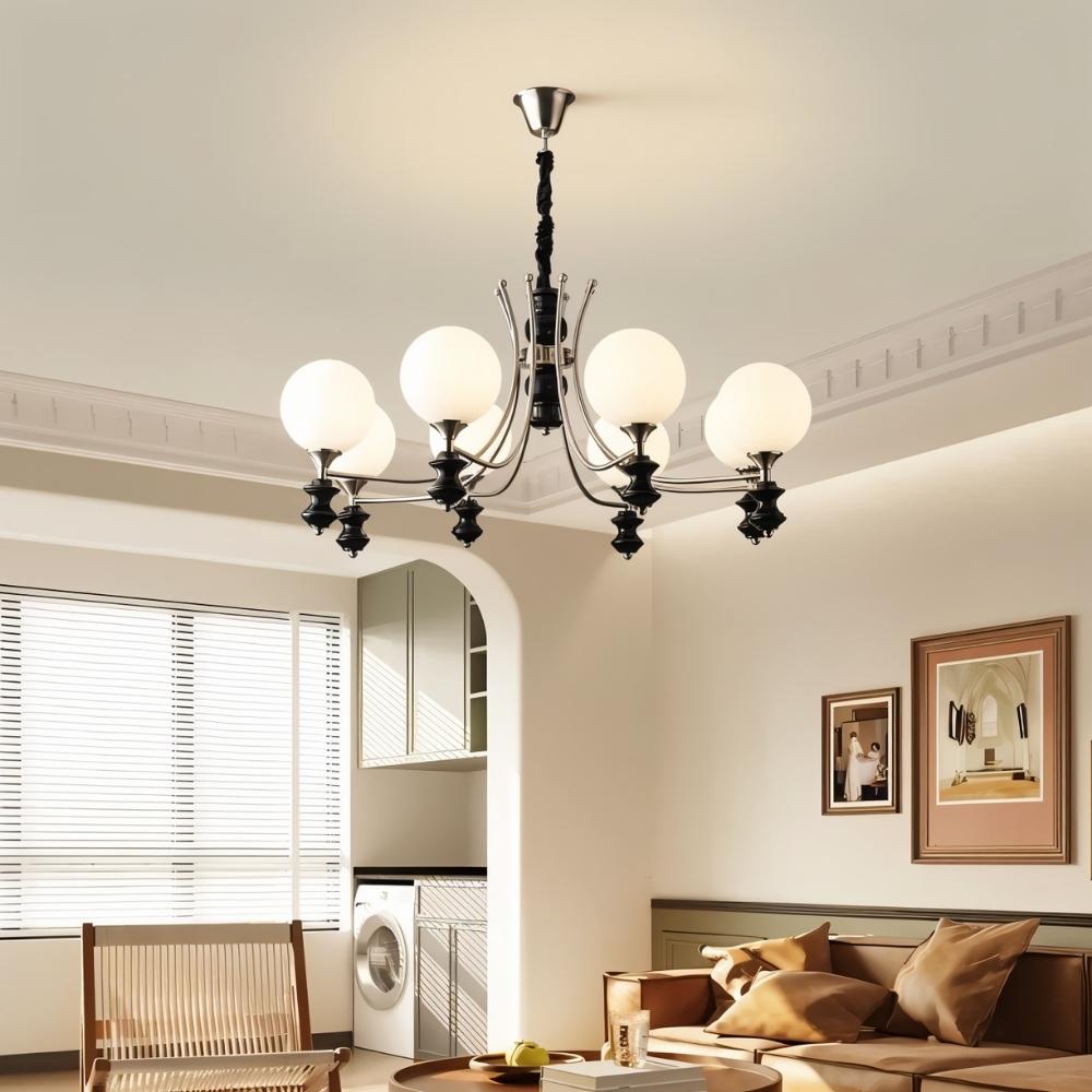  "Modern chandelier with curved arms and frosted glass globes in a contemporary living room."
