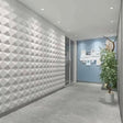 Badra Wall Panel - Stylish 3D Outdoor Wall Panels for Modern Spaces installed in a hallway with recessed lighting and a geometric textured design.