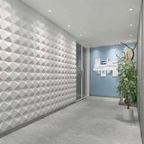 Badra Wall Panel - Stylish 3D Outdoor Wall Panels for Modern Spaces installed in a hallway with recessed lighting and a geometric textured design.
