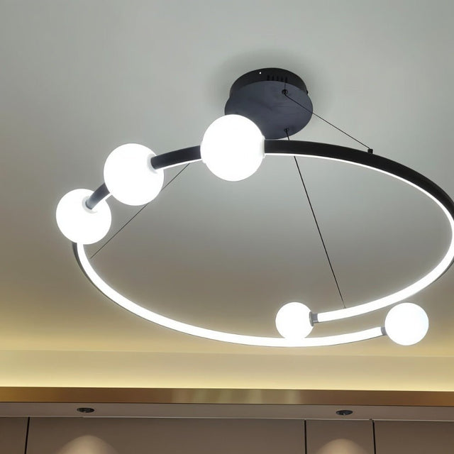 "Modern chandelier with a circular design, featuring minimalist bulb holders and a sleek metal frame."