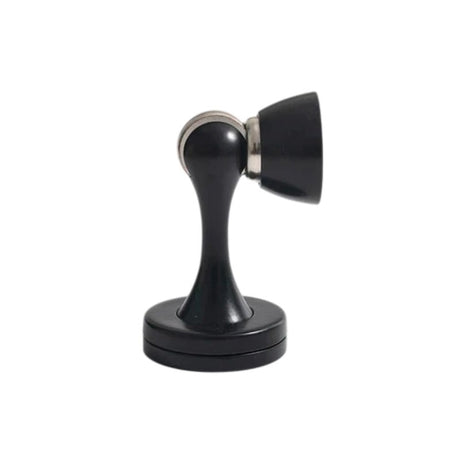 "Sleek, zinc-alloy magnetic door stop with a contoured design, holding a door open to prevent slams and wall damage in modern interiors."
