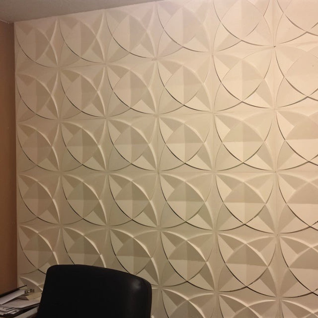 Barku Wall Panel installed in a home office, featuring cream-colored 3D PVC panels with a circular geometric pattern.