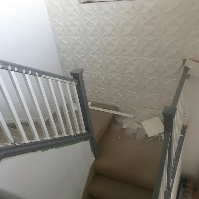 Barku Wall Panel on a staircase wall, featuring white 3D PVC panels with a petal-like pattern for stylish vertical surfaces.