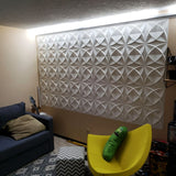 Barku Wall Panel mounted in a cozy entertainment room, displaying white 3D PVC panels with a modern geometric design.