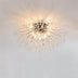 Starburst ceiling light with clear crystal branches and polished chrome finish against white ceiling.