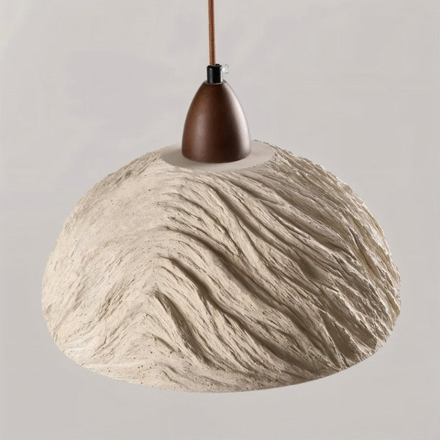 "Wabi Sabi cement pendant light with a minimalist, rounded shade and a dark wood mount, isolated on a light gray background."