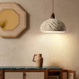 "Wabi Sabi cement pendant light with raw textures and refined imperfections, adding warmth and subtle sophistication to a contemporary space."