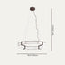 Modern circular pendant light with frosted alabaster shade and bronze hardware, suspended against neutral background.