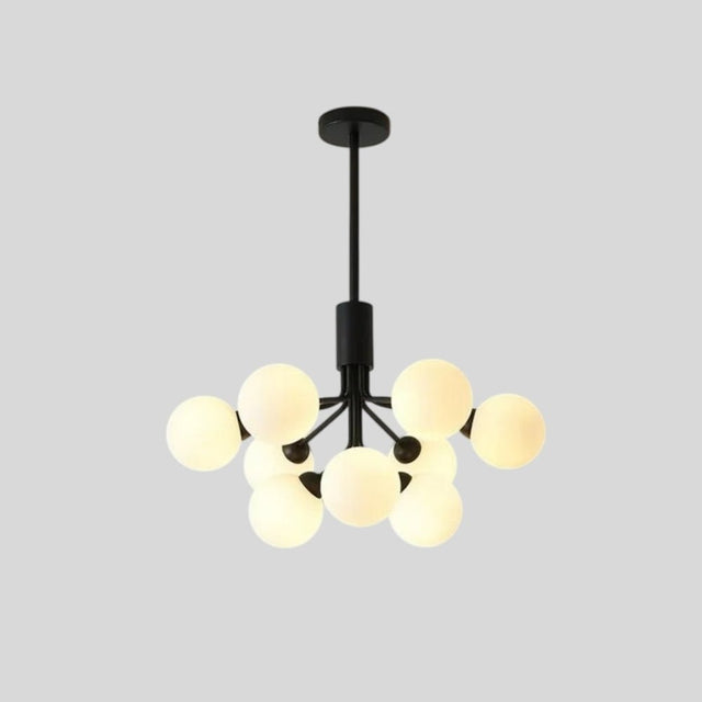 "A black chandelier with glass balls against a grey background."