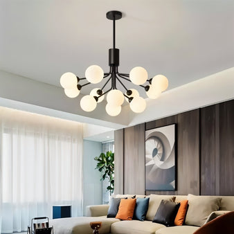 "A black chandelier with glass balls in a living room with a sofa."