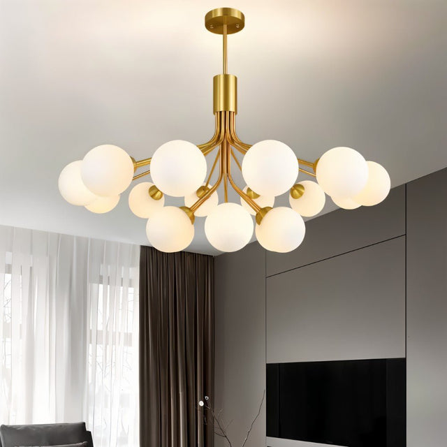 "A gold chandelier with 12 glass balls in a living room with curtains."