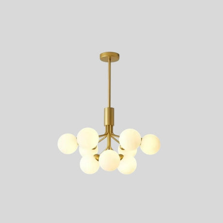 "9 heads gold chandelier with glass balls against a grey background."