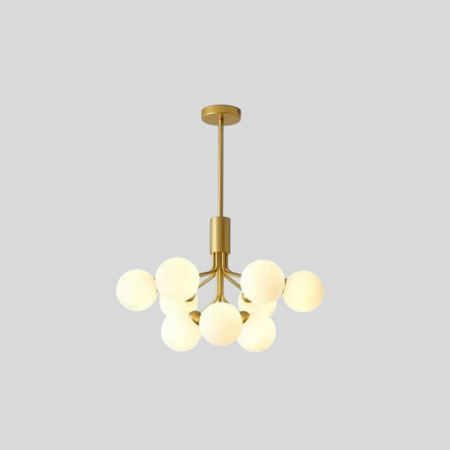 "9 heads gold chandelier with glass balls against a grey background."