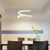 "Modern pendant light with a spiral ribbon design over a dining table in a minimalist dining room."