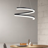"Modern pendant light with a spiral ribbon design over a dining table in a contemporary dining room."
