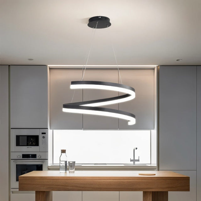 "Modern pendant light with a black spiral ribbon design over a kitchen island."