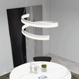 "Modern pendant light with a white spiral ribbon design over a round dining table."