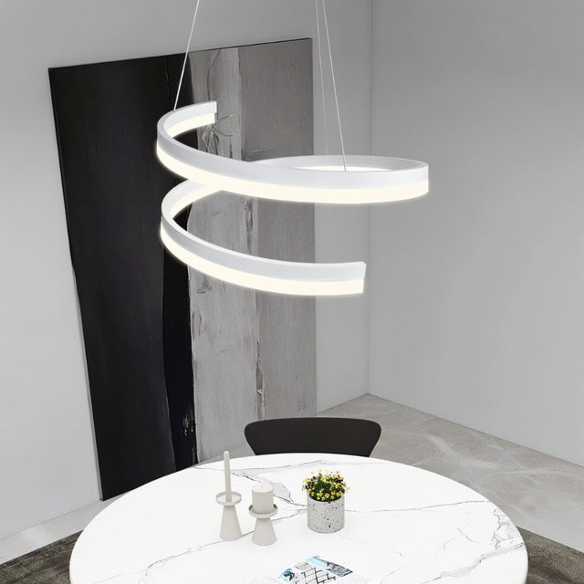 "Modern pendant light with a white spiral ribbon design over a round dining table."