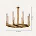 Gold brass round chandelier with ribbed glass cylinder shades on neutral background.