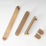 "Set of brass Art Deco cabinet hardware with rounded edges and parallel lines."