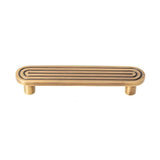 "Brass Art Deco hardware pull with rounded edges and parallel lines."
