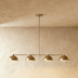 Four-light pendant fixture with dome shades on horizontal pipe, 48 inches wide, studio white background.