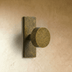Cylindrical cabinet knob with chrome finish on rectangular base, side view against white background.
