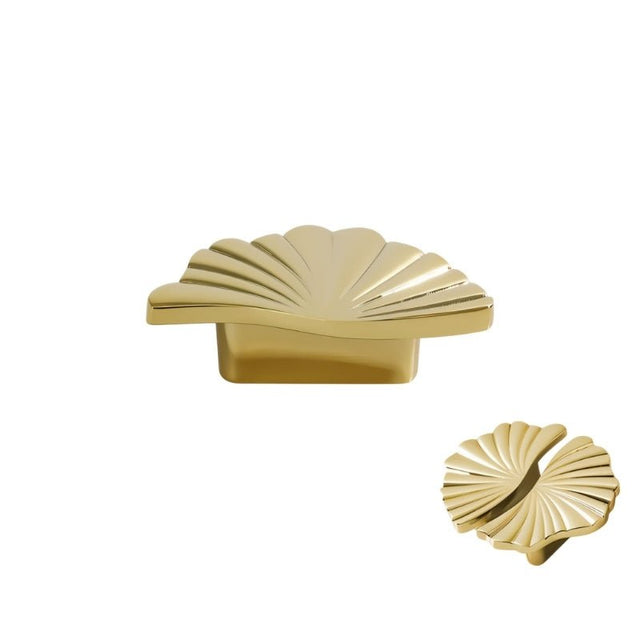 "A gold brass drawer pull with a fan-shaped design, isolated on a white background."