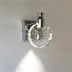 Modern chrome wall sconce with spherical crystal shade featuring embedded LED sparkle effect, mounted on neutral wall.