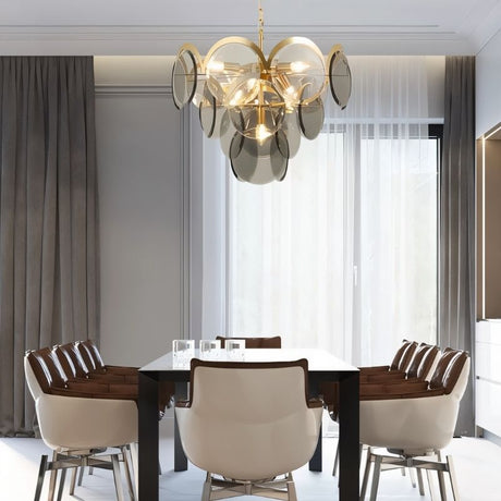"A modern chandelier with layered smoked glass discs hanging above a dining table in a contemporary dining room."