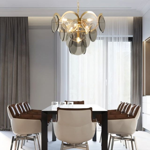 "A modern chandelier with layered smoked glass discs hanging above a dining table in a contemporary dining room."