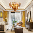 "A modern chandelier with layered amber glass discs hanging in a contemporary living room with neutral tones and gold accents."