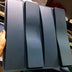 Four dark gray gradient wall panels with curved edges displayed vertically on a white surface.