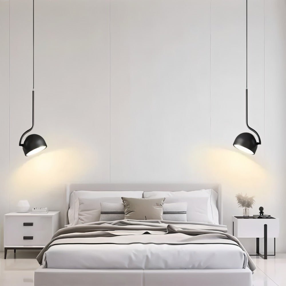 "Two black pendant lights with curved iron fixtures and dome-shaped shades flank a modern bed, providing focused illumination."
