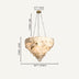 Cream alabaster cluster chandelier with brass fixture suspended against neutral background.
