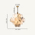 Cream alabaster cluster chandelier with brass hardware suspended against a light background.