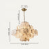 Caelum alabaster chandelier with brass fixture and chain displaying cream and tan stone discs against white background.
