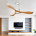 Modern ceiling fan with white motor and curved wood-tone blades in contemporary living room with TV wall.