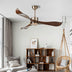 Modern ceiling fan with dark wood blades and brushed brass finish mounted in a contemporary living room.