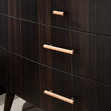 "Close-up of modern wooden drawer pulls with brass accents on a dark wood dresser."