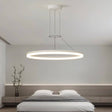 "A modern white ring chandelier in a bedroom with a minimalist design."