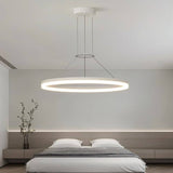 "A modern white ring chandelier in a bedroom with a minimalist design."