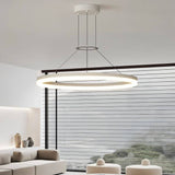 "A modern white ring chandelier in a living room with a large window and seating area."