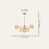 Gold brass chandelier with six illuminated glass globes, shown with dimensions of 27.5" width and 26.7" height.