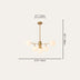 Brass chandelier with five frosted glass globe shades on cream background.