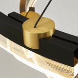 "Close-up detail of a black and gold Capli chandelier showing the aluminum frame, gold connector, and acrylic diffuser."