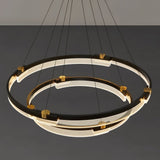 "Close-up of a black and gold Capli chandelier showing the dual aluminum rings and acrylic diffusers."